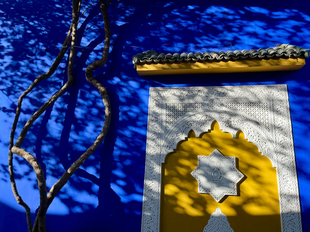 a white and yellow gypsum decoration on a blue wall